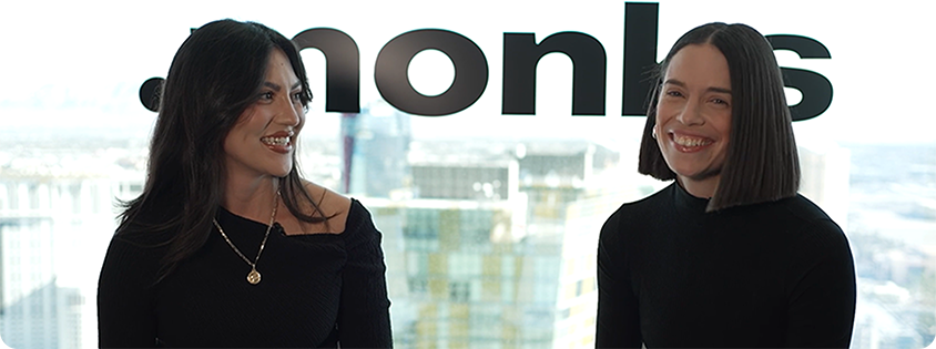 Claire Nance and interviewer sitting on chairs in front of a window.